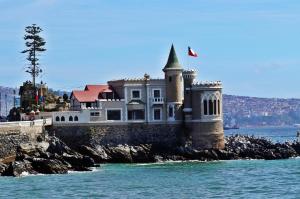 a house on a rocky island in the water at El Retorno a Viña in Viña del Mar