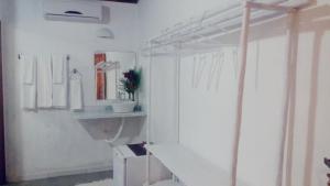 a white bathroom with a sink and a mirror at Pousada João Maria in Trancoso +70 photos