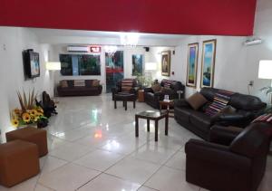 una gran sala de estar con sofás y sillas. en Hotel del Sur, en San Lorenzo