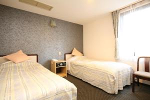 Postel nebo postele na pokoji v ubytování Nagano Plaza Hotel