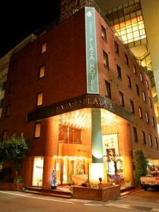 a building with a sign on the front of it at Nagano Plaza Hotel in Nagano