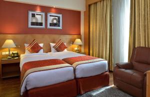 Postel nebo postele na pokoji v ubytování Savoy Suites Manesar + 26 fotografií