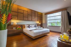 a hotel room with a bed and a large window at Entrada Seminyak Villa By Nagisa Bali in Seminyak +33 photos