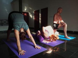 a man and a woman doing a yoga pose at Vedic Heritage Boutique Hotel in Kovalam
