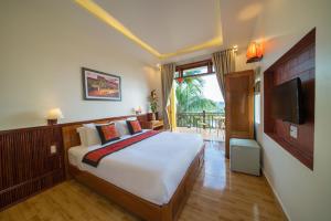 a bedroom with a large bed and a television at Lakeview Villa Homestay in Hoi An +42 photos