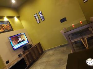 a living room with a tv and a fireplace at Belen - Service Apartment in Mangalore