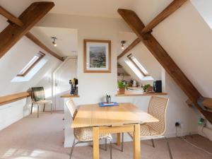 a dining room with a wooden table and chairs at The Leat at Wynyard Mill in Malmesbury