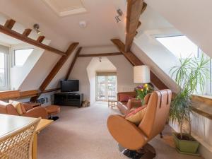 a living room with a vaulted ceiling with wooden beams at The Leat at Wynyard Mill in Malmesbury
