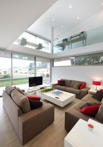 a living room with two couches and a tv at La casa de Marta in Celorio