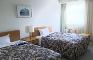 Postel nebo postele na pokoji v ubytování Saku Grand Hotel