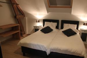 Letto o letti in una camera di Logies Tommenmolen