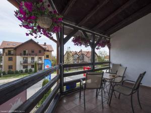 a balcony with a table and chairs and a view at Przystań Smaku adults only in Krynica Morska