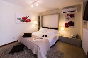 a bedroom with a bed with a book on it at Arena Dreams Apartment in Verona