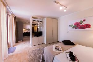 a bedroom with a bed and a room with a television at Arena Dreams Apartment in Verona