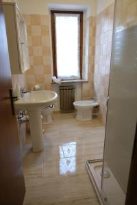 a bathroom with a sink and a toilet and a window at B&B LUNA in Seriate