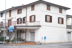 a white building with a balcony on a street at B&B LUNA in Seriate