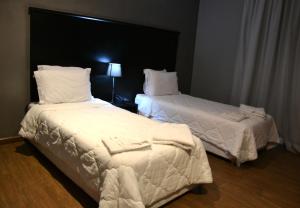 Ένα ή περισσότερα κρεβάτια σε δωμάτιο στο Ubay Hotel