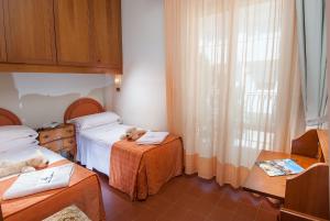 Postel nebo postele na pokoji v ubytování Hotel Dea