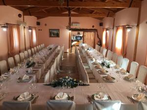 a long table in a room with white tables and chairs at Case Vacanza Fiocchi in Arrone +9 photos