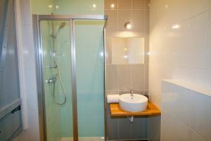 a bathroom with a glass shower and a sink at Casa dos Batalim in Monchique +30 photos