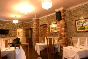 un ristorante con due tavoli con tovaglia bianca di Ardgort Country House a Castlederg