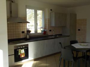 a kitchen with a table and a sink and a window at Casa Torboli in Arco