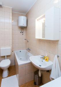 a bathroom with a white sink and a toilet at Apartment & Room Braica in Dubrovnik