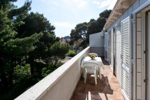 a small balcony with a table and chairs on it at Apartment & Room Braica in Dubrovnik