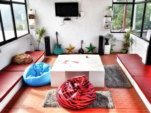 a living room with a couch and a coffee table at Hostel Cozy Beds in Rishīkesh