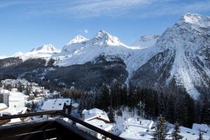 a view of a snow covered mountain with a town at Chamanna Bed & Breakfast in Arosa
