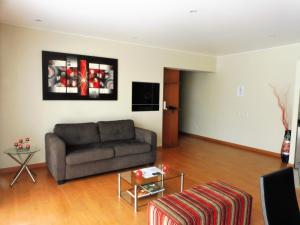 a living room with a couch and a table at Miraflores 1Bed and Balcony in Lima