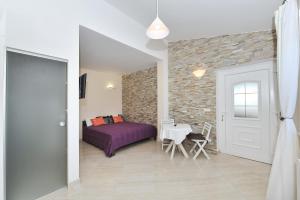 Postel nebo postele na pokoji v ubytování Apartments Dominique
