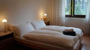 a bedroom with a bed with a black bag on it at Apartment Belvedere in Wengen