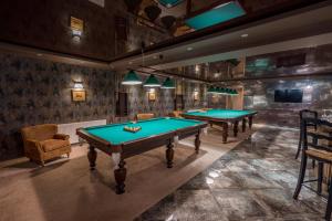 a large room with a pool table and chairs at Hotel GoodAura in Gudauri