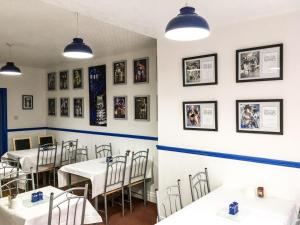 a dining room with tables and pictures on the walls at Willow Dene in Scarborough
