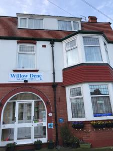 a white and red building with a window dmg at Willow Dene in Scarborough