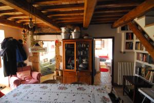 uma sala de estar com uma mesa e uma estante de livros em Casa con vista mozzafiato su Civita di Bagnoregio em Lubriano
