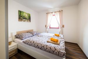 a bedroom with a bed with two pillows on it at Apartments Planina pod Sumikom in Planina pod Sumnikom