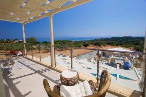 un balcon avec des chaises et une vue sur l'océan dans l'établissement Villa Ion Pangea Villas, à Trapezaki 9 autres photos