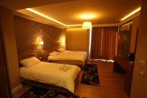 Postel nebo postele na pokoji v ubytování Perla Hotel