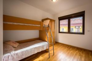 a bedroom with two bunk beds and a ladder at Apartment Seaside Home in Rafailovici