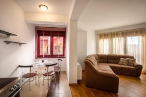 a living room with a couch and a table at Apartment Seaside Home in Rafailovici