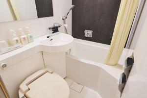 a small bathroom with a sink and a toilet at Urayasu Sun Hotel in Urayasu