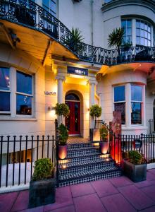 a house with a staircase leading to a red door at Hotel Una in Brighton & Hove