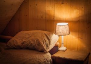 een slaapkamer met een bed en een lamp op een tafel bij Hof ter Sysen in Loppem