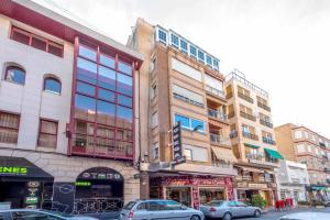 a group of buildings on a city street with cars at Torrevieja in Torrevieja