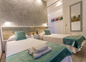 プエルト・デ・ラ・クルスにあるホテル サン ホリデーズのベッド2台と鏡が備わるホテルルームです。