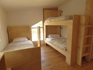 Łóżko lub łóżka piętrowe w pokoju w obiekcie Quilda Hostel