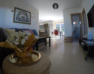 a living room with a vase of flowers on a table at Bajamar 152 in Bajamar