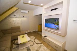 Un televizor și/sau centru de divertisment la Chez moi +6 fotografii